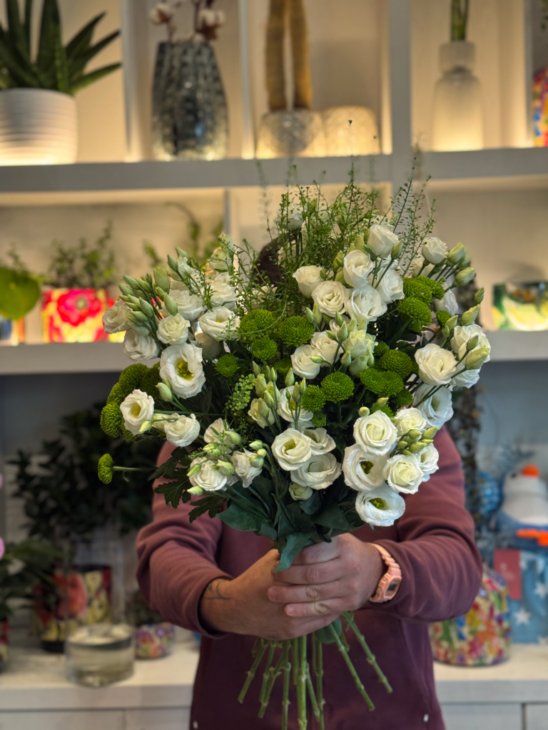 Αντλεί έμπνευση από την πρωινή δροσιά ενός κήπου και δημιουργεί μια ανθοδέσμη όπου το λευκό φως των λουλουδιών συναντά τη ζωντάνια του πράσινου, προσφέροντας ένα αποτέλεσμα που ηρεμεί και ανανεώνει. Είναι η ιδανική επιλογή για όσους αγαπούν τις καθαρές γραμμές και τη φυσική ομορφιά.